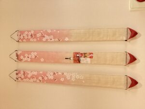 細長い布地に雛祭り、桜の絵柄が書かれている布飾り3本の写真